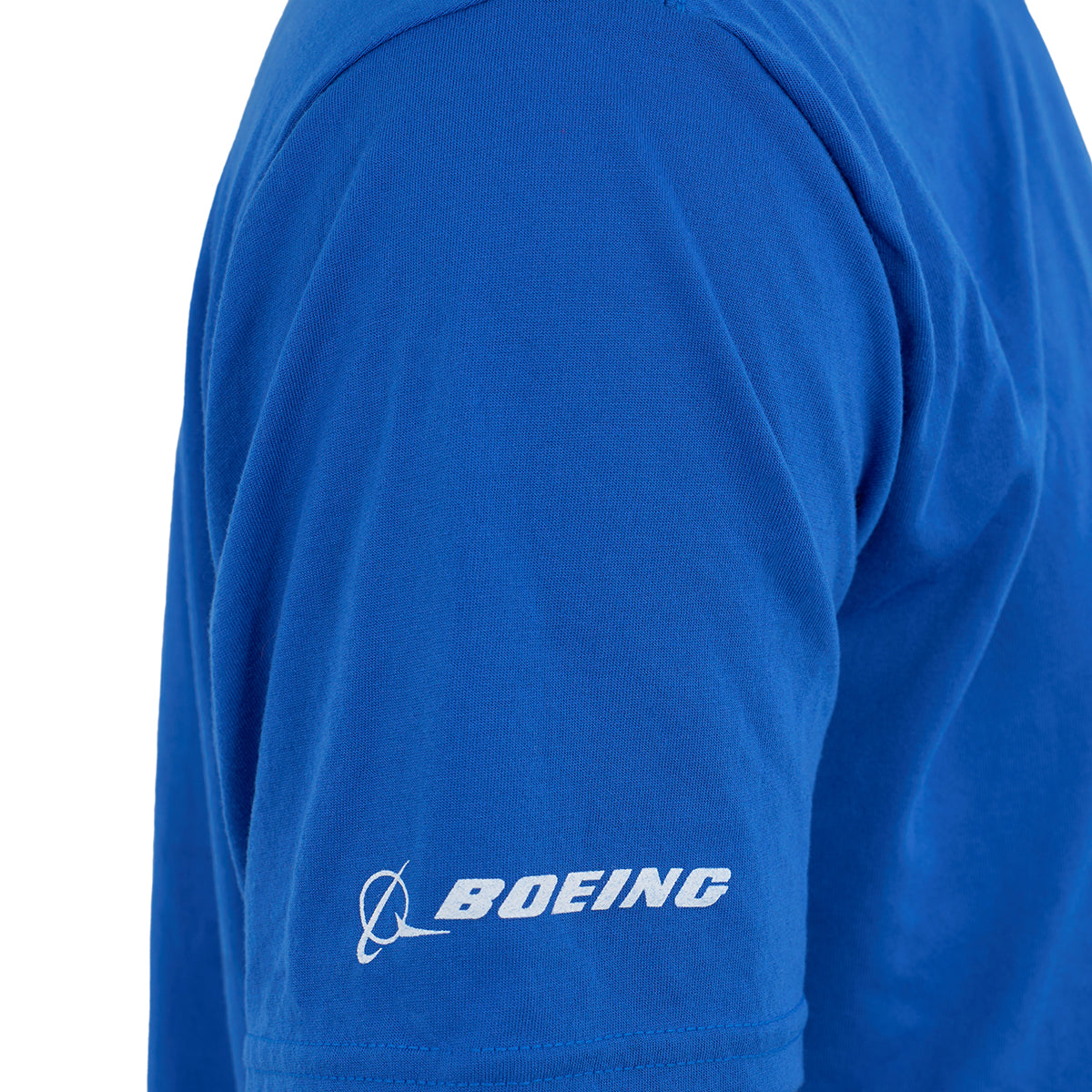 A close-up of a person wearing the Boeing 787 Dreamliner Series Unisex T-Shirt by BOEING in bright blue, featuring moisture-wicking fabric and the white Boeing logo and name printed on the left sleeve.