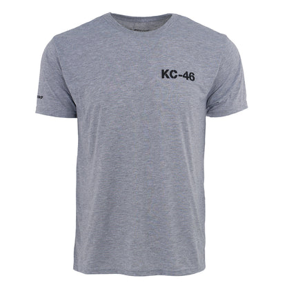 The Boeing KC-46A Pegasus Series Unisex T-Shirt by BOEING features heather gray, moisture-wicking fabric, a relaxed fit, crew neckline, black KC-46 graphic on the chest, and a small Boeing logo on the left sleeve—perfect for aviation fans.