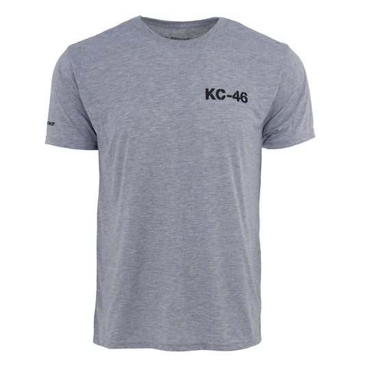 The Boeing KC-46A Pegasus Series Unisex T-Shirt by BOEING features heather gray, moisture-wicking fabric, a relaxed fit, crew neckline, black KC-46 graphic on the chest, and a small Boeing logo on the left sleeve—perfect for aviation fans.