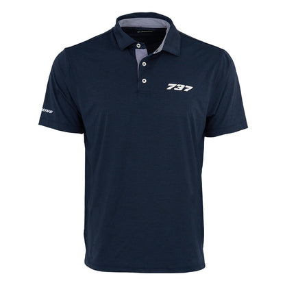 The Boeing 737 Series Men’s Polo by BOEING is a navy blue, moisture-wicking shirt with “737” in white on the left chest and “Boeing” on the sleeve. It features a folded collar, three-button placket, and keeps you cool and dry all day.