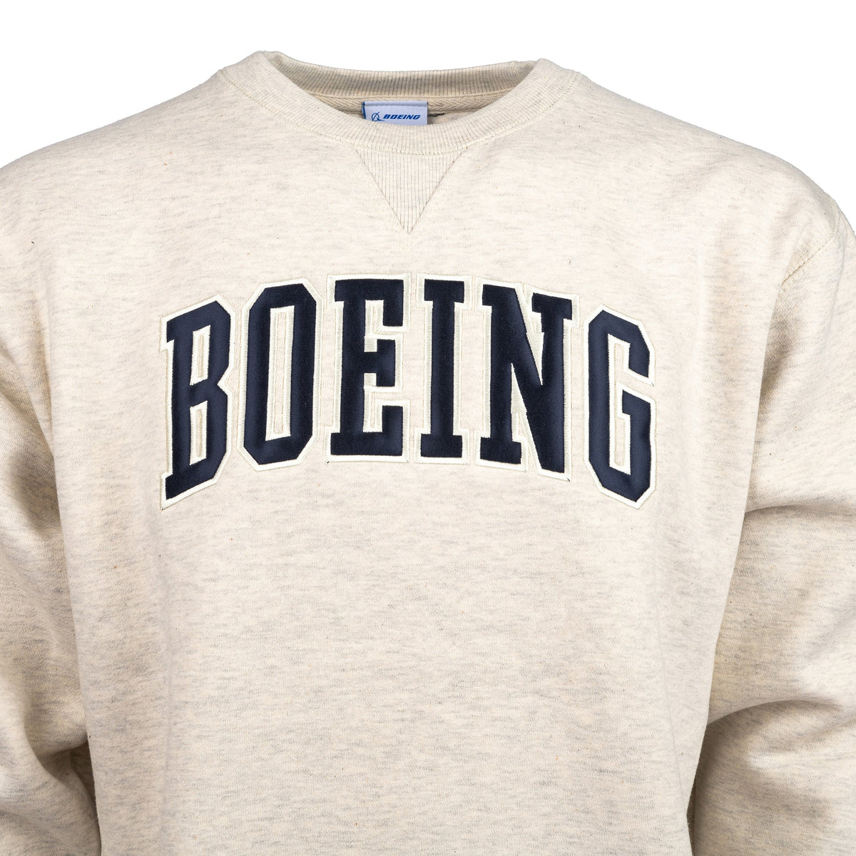 Close up of the adult crewneck sweater in oatmeal color.  Dark navy Boeing varsity logo across the chest.