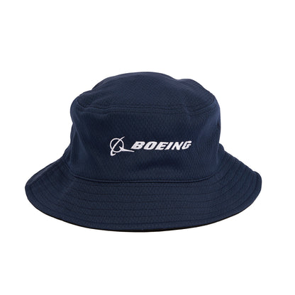The Boeing Stores Boeing Signature Logo Performance Bucket Hat features a navy blue color with the Boeing logo and name embroidered in white on the front. It offers sun protection and moisture-wicking capabilities, thanks to its wide brim and textured fabric, ensuring ultimate comfort.