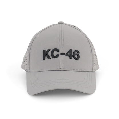 The BOEING KC-46A Pegasus Series Hat is a light gray baseball cap with a bold 3D KC-46 logo on the front and an adjustable velcro closure for comfort, shown facing forward against a white background.