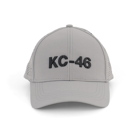 The BOEING KC-46A Pegasus Series Hat is a light gray baseball cap with a bold 3D KC-46 logo on the front and an adjustable velcro closure for comfort, shown facing forward against a white background.