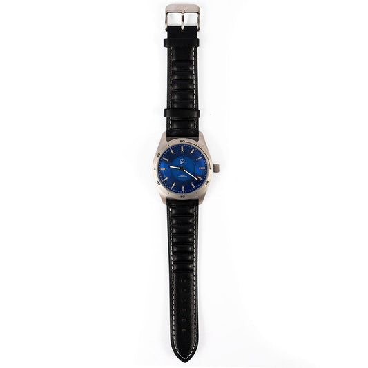 The Boeing Store’s Boeing Symbol Men's Solar Watch 42 mm features a round blue face, silver case, and black leather strap with white stitching. It uses Japanese solar movement and displays 8:19 on a white background.