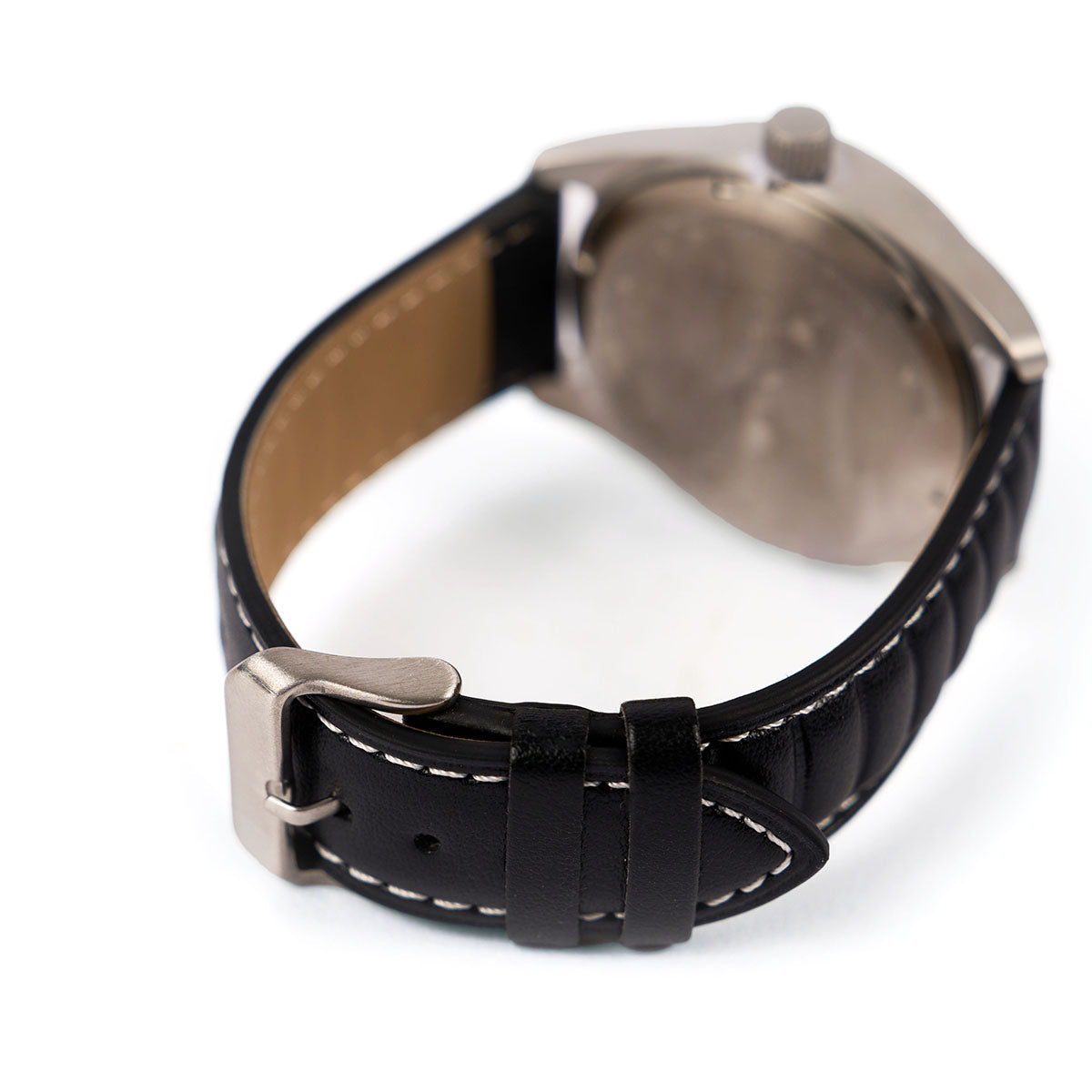 A close-up of The Boeing Store’s Boeing Symbol Men's Solar Watch 42 mm, featuring a black AppleSkin leather strap, metal buckle, and the back of the case against a white background.