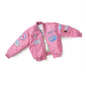 The Boeing Store offers the Boeing Kids Pink Aviator Jacket, a nylon flight jacket with ribbed cuffs and hem. It features a front zipper, patterned lining, and blue-red plane and star patches that highlight its aeronautical appeal—perfect for aviation enthusiasts.