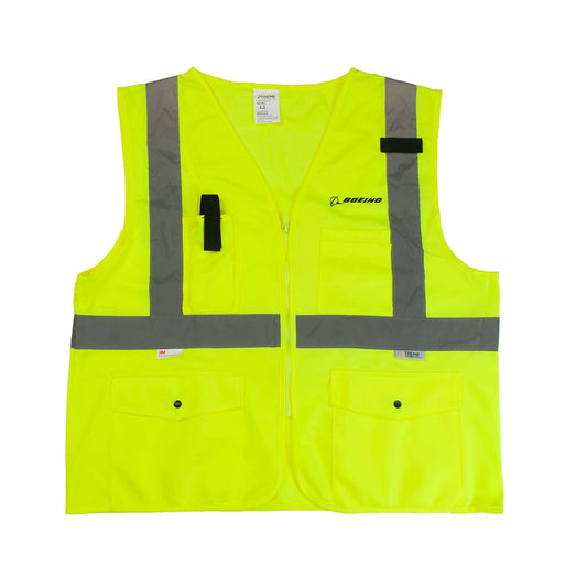 The Boeing Stores Boeing Class 2 Surveyor Safety Vest offers Xtreme Visibility with its bright yellow color, gray reflective stripes, multiple pockets, zipper front, accessory loops, and prominent chest logo. It meets ANSI 107-2015 safety compliance standards.