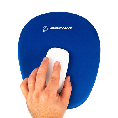 A hand uses a white mouse on the Boeing Memory Sponge Mousepad from The Boeing Store, featuring the Boeing logo and text at the top, set against a white background.