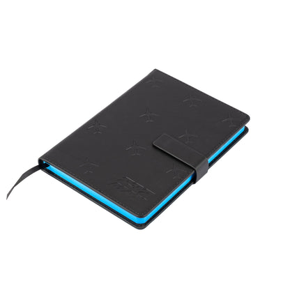 The Boeing Store’s Boeing 737 MAX Notebook features a closed black PU hardcover with an embossed aircraft design, blue-edged pages, black strap closure, and ribbon bookmark, displayed on a white background.