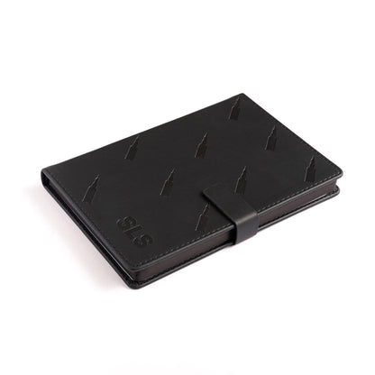The Boeing Stores Boeing SLS Notebook is a sleek, black leather notebook with a subtle embossed pattern and clasp closure. It features SLS in the corner and offers a stylish, professional look perfect for aviation enthusiasts and reminiscent of Boeings aircraft precision.