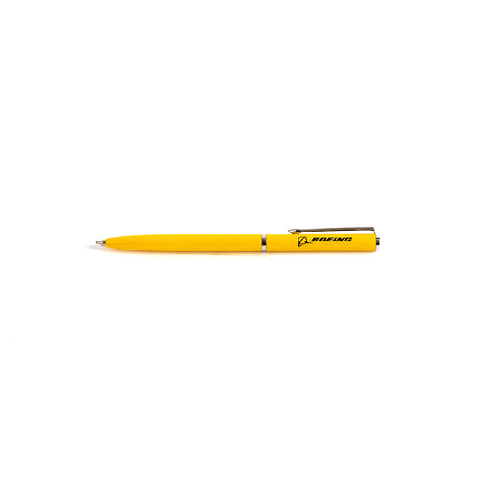 A sleek Boeing Mini Slim Ballpoint Pen, yellow with a silver clip and Boeing logo in black, crafted from brass by The Boeing Store, lies horizontally on a plain white background.