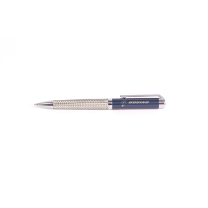 The Boeing Store offers the sleek Boeing Braided Steel Pen, featuring a textured grip with a blue cap branded in white. This elegant pen, displayed horizontally on a white background, is part of an exclusive set that complements any gift box.