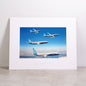 A Boeing 737 MAX Family Sky Matted Print - Large showing three airplanes flying in formation over a landscape under a clear blue sky.