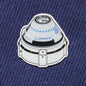 A Boeing Illustrated Starliner Lapel Pin by The Boeing Store features a spacecraft design on blue fabric. It showcases an epoxy finish and small logos, including the Boeing logo, for a realistic touch.