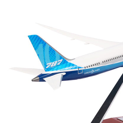 Close-up of a Boeing Unified 787-10 Dreamliner 1:200 Model tail, showcasing blue and white colors with 787 on the vertical stabilizer. From The Boeing Store, this model represents the sleek design of a 787-10 Dreamliner and is mounted on a black stand.