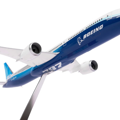 The Boeing Stores Boeing Unified 787-10 Dreamliner 1:200 Model, part of the iconic 787 family, is mounted on a stand. It features blue and white colors with the Boeing logo visible on the side and wings and has two prominently displayed engines under its wings.