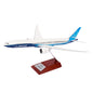 The Boeing Stores Boeing Unified 777-9 1:200 Model showcases a blue and white sleek design on a wooden base with a plaque featuring 777X and Boeing branding, making it ideal for aviation enthusiasts. It highlights detailed wings and engines as a prized piece of memorabilia.
