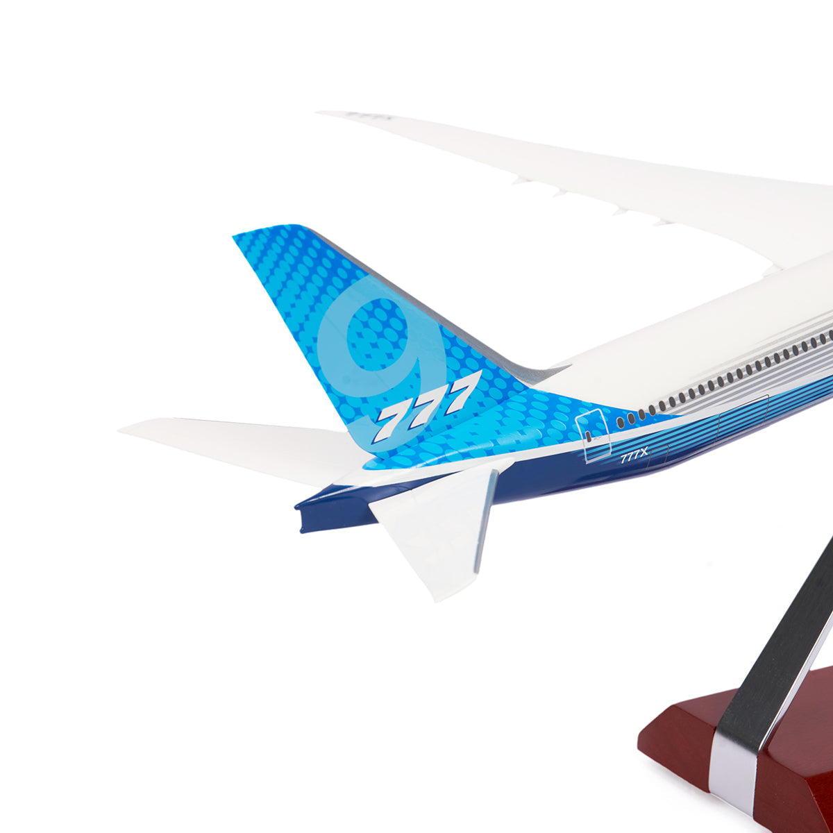 The Boeing Stores Unified 777-9 1:200 Model showcases a blue gradient tail with the number 777, ideal for aviation enthusiasts. Sitting elegantly on a wooden-based stand, this piece makes perfect Boeing memorabilia.