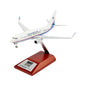 The BOEING Boeing 737-700 Freedom Plane 1:200 Model features a white body with blue and red stripes, an American flag on the tail, and is displayed on a wooden stand with a metal plaque.