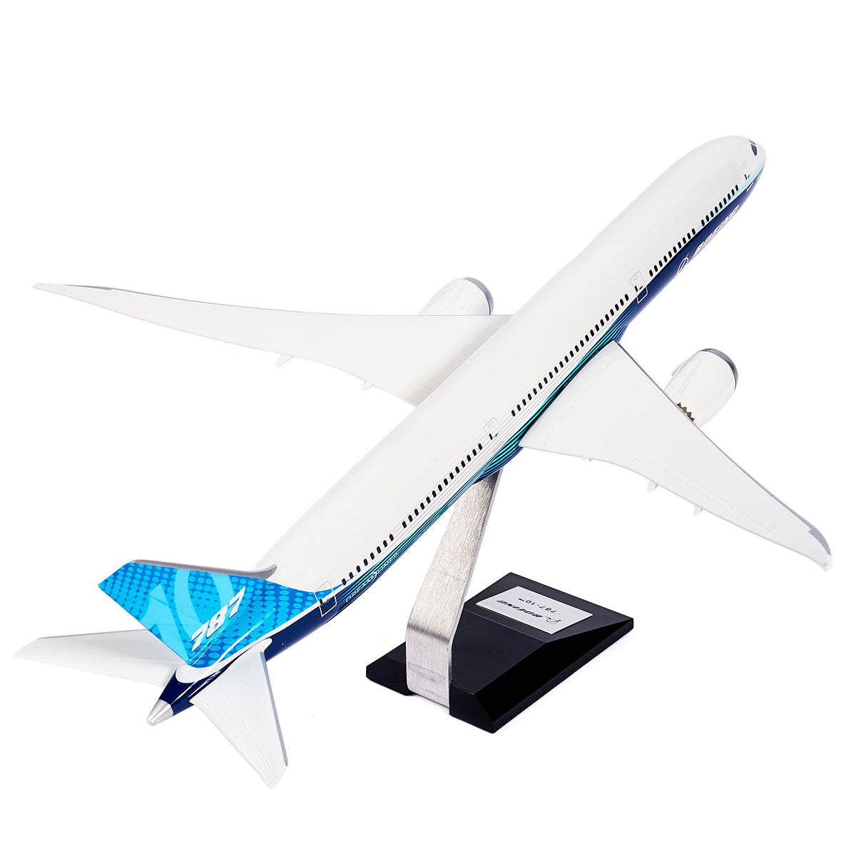 The Pacific Miniatures Boeing Unified 787-10 Dreamliner Plastic 1:144 Model features a white body, blue accents, “787” on the tail, and is presented on a metal stand with a black base.