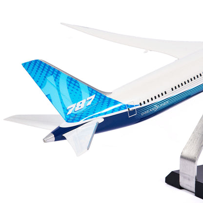 A close-up of the Pacific Miniatures Boeing Unified 787-10 Dreamliner Plastic 1:144 Model’s blue tail, showing the white 787 and Dreamliner logo, mounted on a metal stand against a white background.