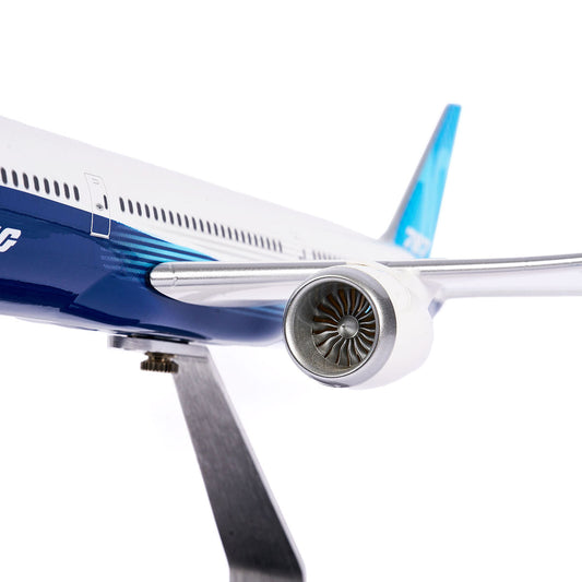 Close-up of the Pacific Miniatures Boeing Unified 787-10 Dreamliner Plastic 1:144 Model, featuring the right wing, jet engine, and fuselage in a blue and white scheme on a metal stand against a white background.