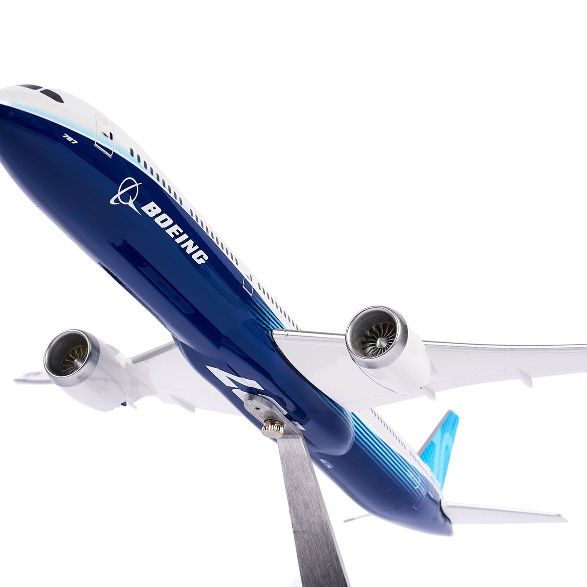 The Pacific Miniatures Boeing Unified 787-10 Dreamliner Plastic 1:144 Model is shown on a stand against a white background, featuring a close-up from below that highlights its engines and wings.