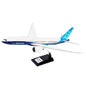The Boeing Stores Boeing Unified 777-8 1:144 Model features a sleek white and blue design with a distinctive tail fin. Mounted on a black stand with a silver plaque, this model captures the elegance and innovation of modern twin-engine jets.