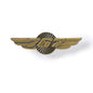 The Boeing 767 Wings Pin by Boeing is a unisex tie tack featuring outstretched wings and the number 767 at the center, designed with an antiqued brass finish and displayed on a white background.