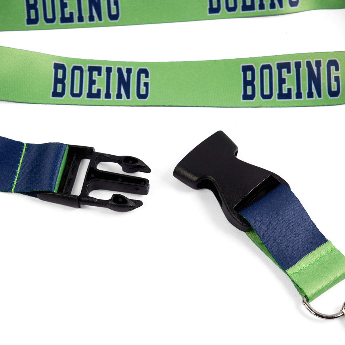 The Boeing Varsity Lime Lanyard by Boeing features green and blue colors, sublimation printed logo, bold BOEING lettering, black plastic buckle, safety breakaway, and metal ring attachment.