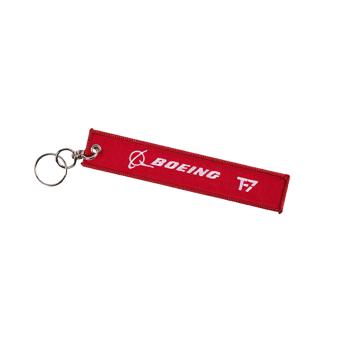 The Boeing T-7A Remove Before Flight Keychain is a red fabric accessory with a metal ring, showcasing a white Boeing logo and Remove Before Flight design.