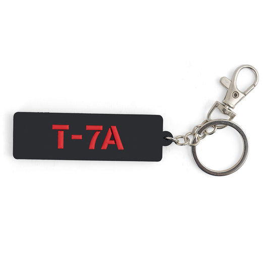 The BOEING T-7A Red Hawk Series Keychain is a black rectangular keychain with T-7A in red letters, attached to a metal ring and clasp—ideal for aviation enthusiasts and Boeing fans.