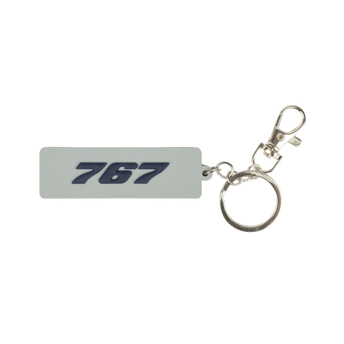 The BOEING 767 Series Keychain is a light gray, rectangular rubber accessory featuring "767" in bold, dark blue, embossed lettering. This aviation-themed keychain comes attached to a silver metal split ring and a lobster claw clasp, all showcased against a plain white background.