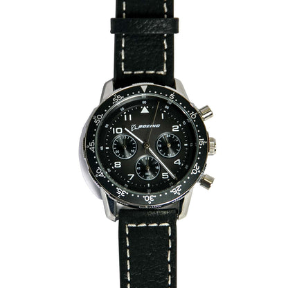 The Boeing Stores Boeing Black Leather Watch features a stainless steel case resistant up to 10 ATM, a dial with the Boeing logo, three subdials, and white numerals on the bezel. It has a black strap with white stitching and is powered by precise Japanese movement.
