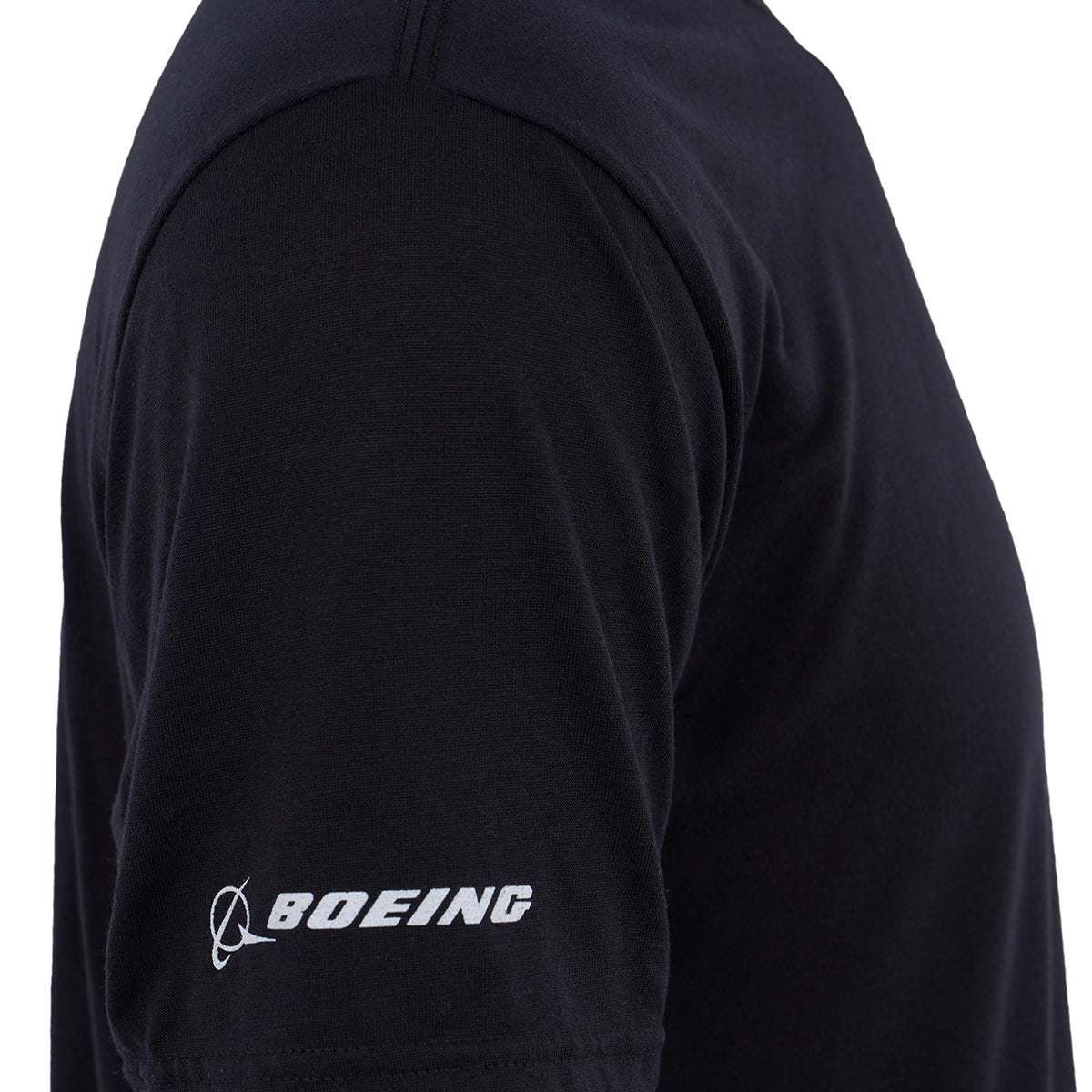 A close-up of a persons upper arm wearing the Boeing V-22 Osprey Series Unisex T-Shirt by BOEING, black and moisture-wicking with a white logo on the sleeve—ideal for aviation enthusiasts.
