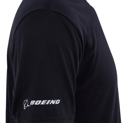Close-up of a person’s upper arm in a black Boeing Space Launch System Series Unisex T-Shirt by BOEING, featuring moisture-wicking fabric and the white Boeing logo on the sleeve. Perfect for aviation enthusiasts. Plain white background.