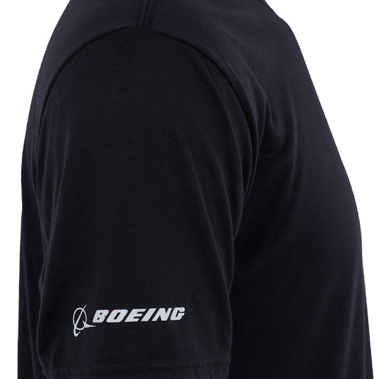 Close-up of a person’s upper arm in a black Boeing Space Launch System Series Unisex T-Shirt by BOEING, featuring moisture-wicking fabric and the white Boeing logo on the sleeve. Perfect for aviation enthusiasts. Plain white background.