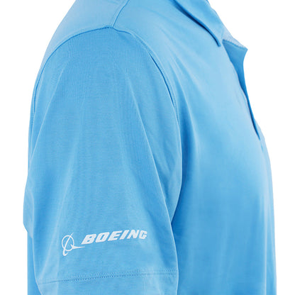 A person wearing the BOEING 777 Series Men’s Polo in light blue, featuring a white Boeing logo on the left sleeve. The moisture-wicking fabric is visible, with the photo cropped to show only the shoulder, sleeve, and part of the chest.