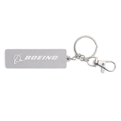 The Boeing F-15 Eagle Series Keychain by BOEING features a rectangular gray design with the logo and name in white, attached to a metal keyring and lobster clasp—ideal for aviation fans.