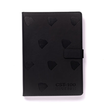 The Boeing CST-100 Starliner Notebook by The Boeing Store is a black PU hardcover with embossed triangular patterns, a right-side clasp, and the text CST-100 STARLINER elegantly embossed in the bottom right corner, all on a sleek plain white background.
