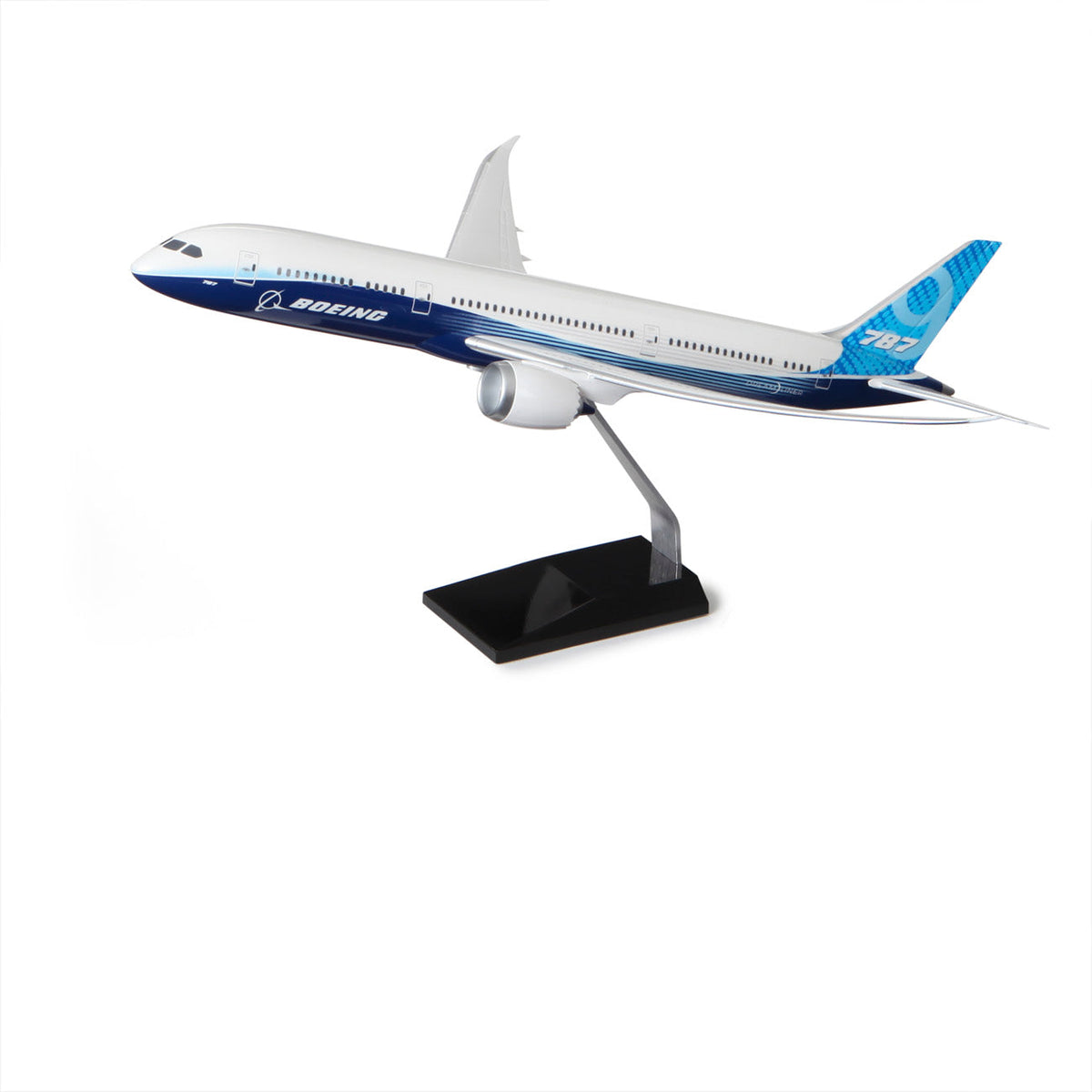 The Boeing Stores Boeing Unified 787-9 Dreamliner Plastic 1:144 Model features blue and white livery, a black stand, and is displayed against a plain white background.