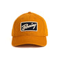 The Boeing Stores Boeing Washed Twill Patch Hat is a mustard-yellow baseball cap with a curved brim, showcasing an embroidered patch that reads Boeing in white on black. It features the Boeing script logo and has an adjustable buckle closure for a perfect fit.